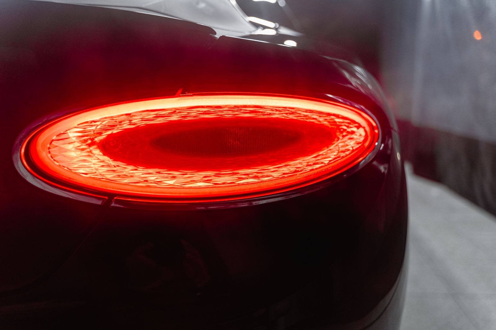 Tail light glowing on a dark car